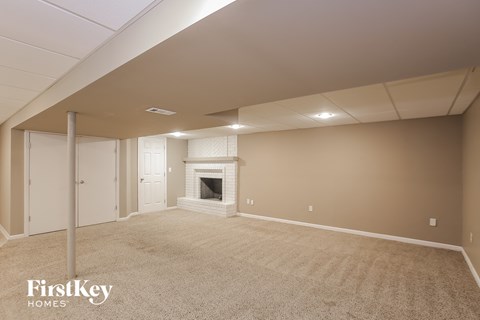 a living room with a fireplace and a carpeted floor