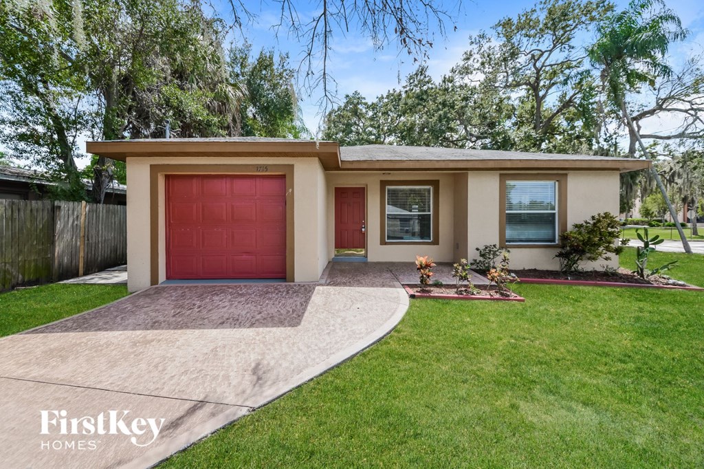 A house with a red garage door is for sale.