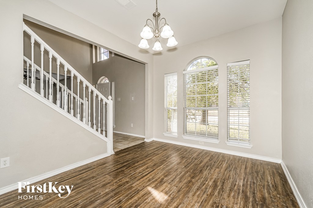 the living room and entryway of an empty house