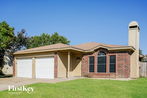 A house with a brown roof and a chimney is for sale.