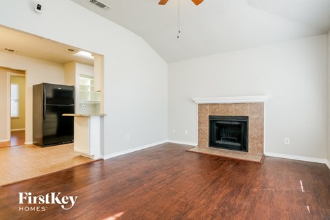 A living room with a fireplace and a television.