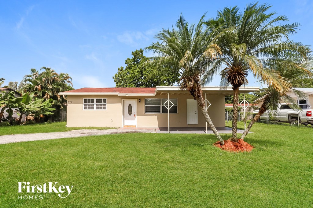 a house with palm trees in front of it