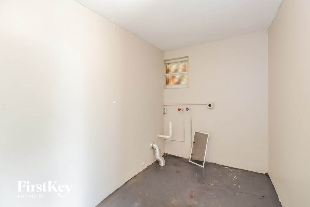 a small room with a white wall and a radiator in it