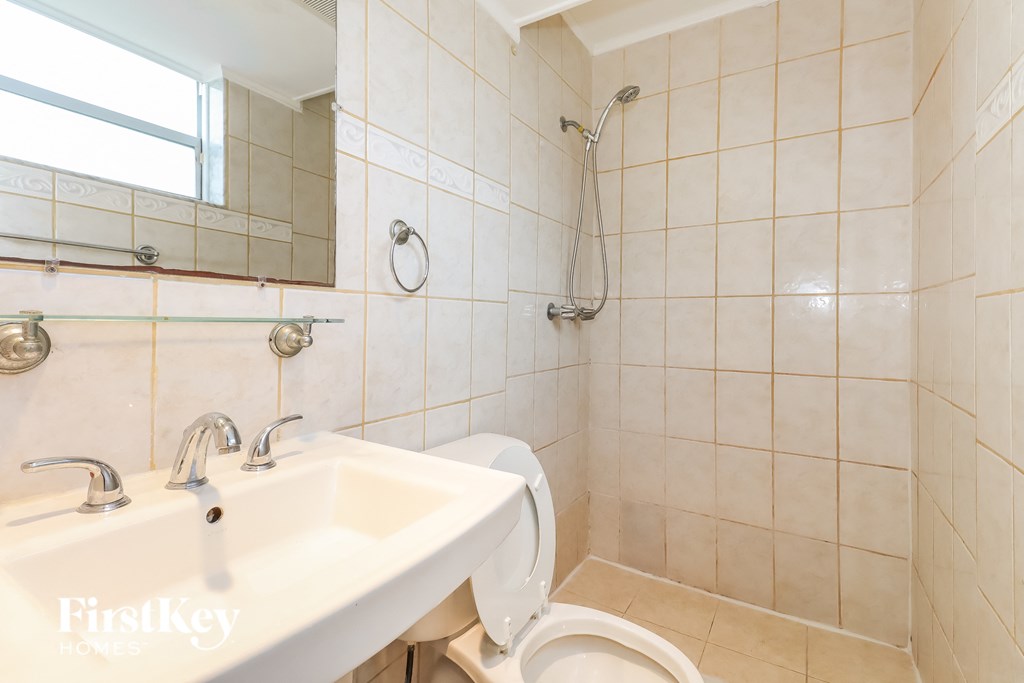 a bathroom with a sink and a toilet and a shower