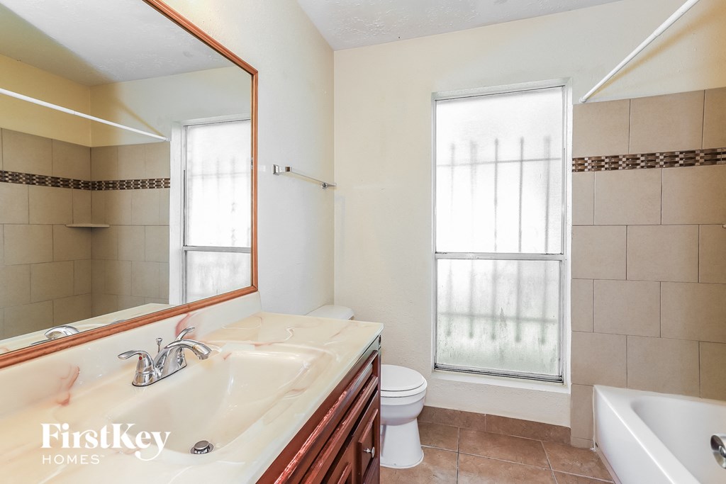 a bathroom with a sink and a toilet and a tub