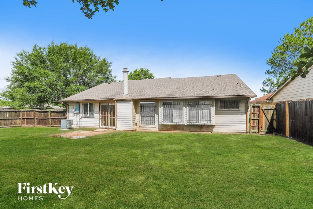 a white house with a yard and a fence