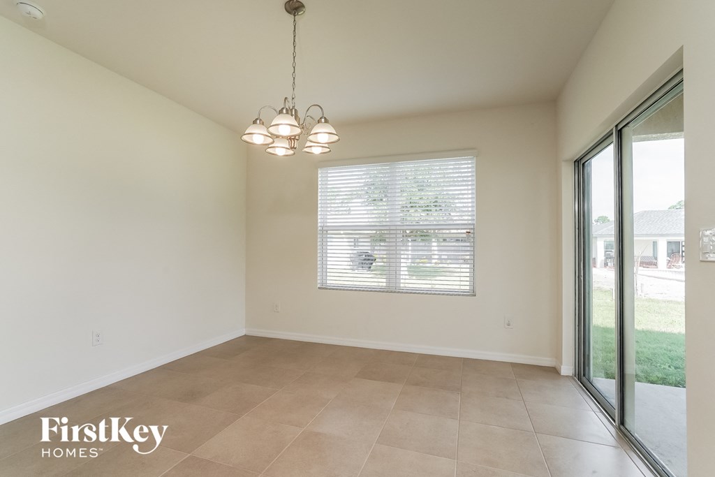 A room with a sliding glass door leading to a backyard.