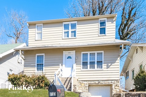 a white house with a white door and white stairs