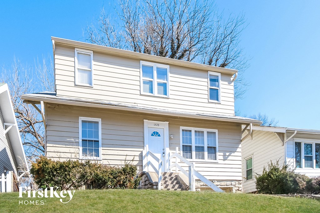 a white house with a blue sky in the background