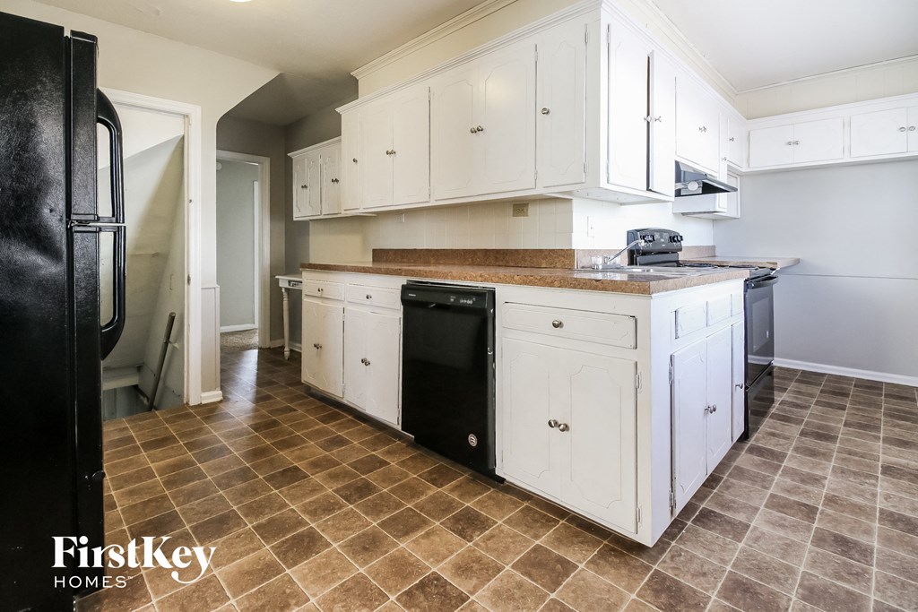 a kitchen with white cabinets and a counter top