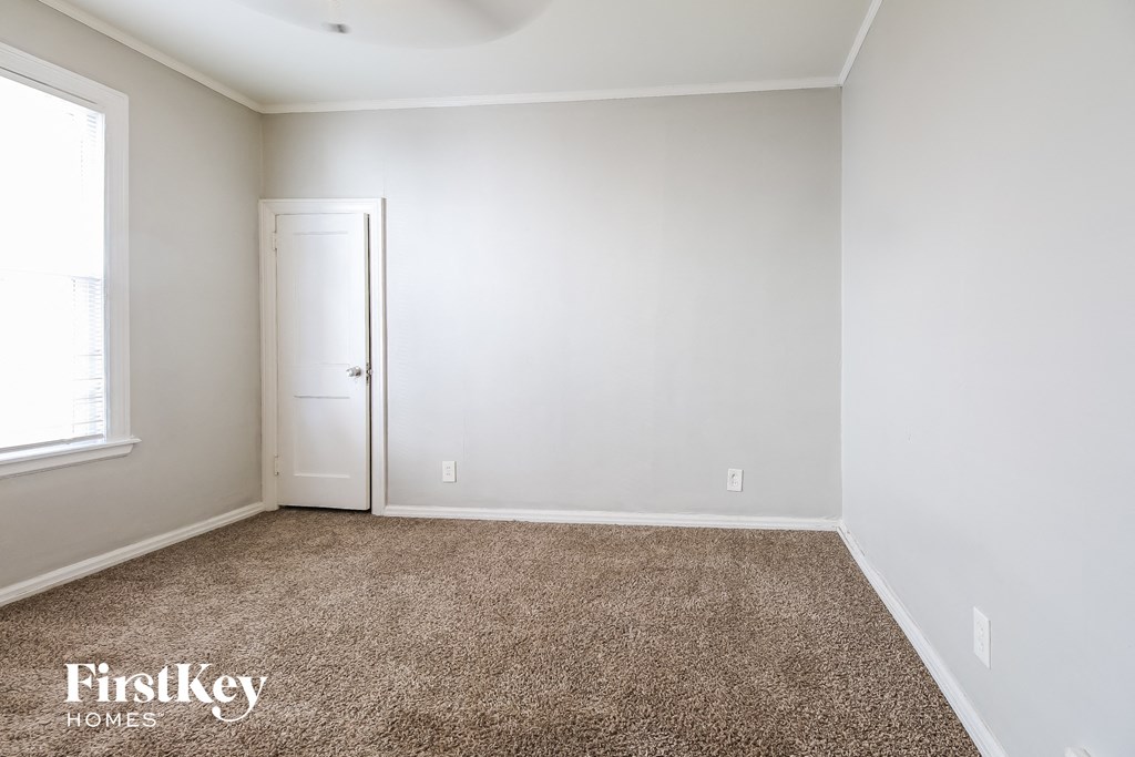 a room with a carpeted floor and a white door
