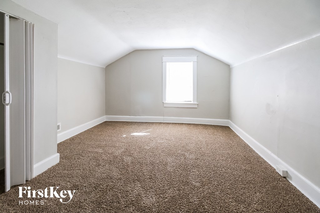 a room with a carpeted floor and a window