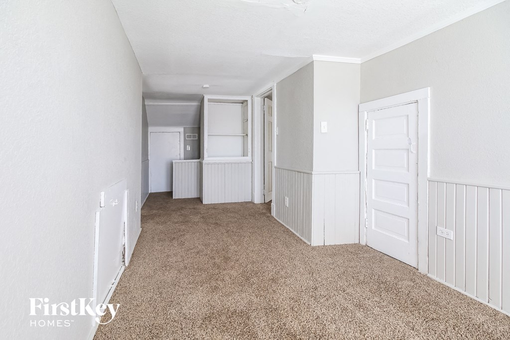 a bedroom with white walls and a carpeted floor    and a closet
