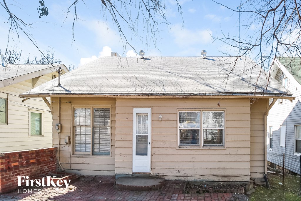 the front of a yellow house with a white roof