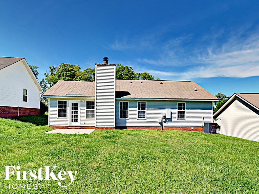 a small white house with a yard in front of it
