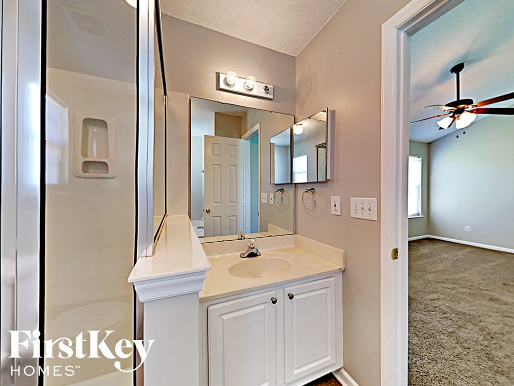 an empty bathroom with a sink and a mirror