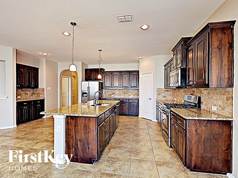 a kitchen with wooden cabinets and a counter top
