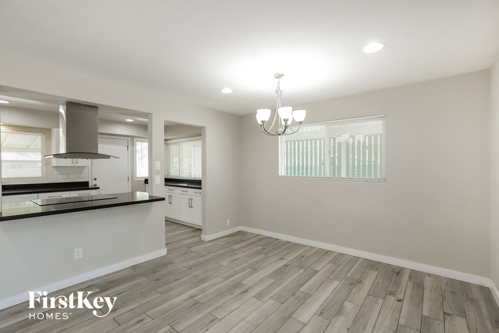 the kitchen and dining room of a new home with hardwood flooring