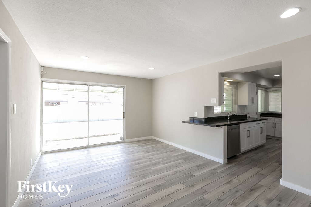 an empty living room and kitchen in a new home