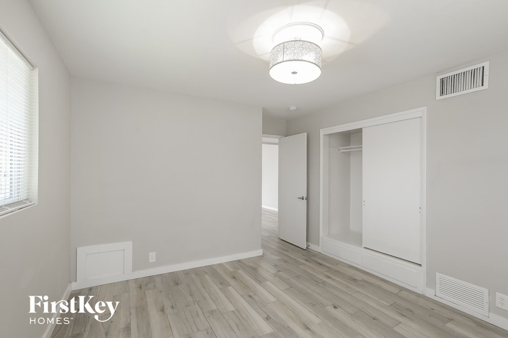 a renovated living room with white walls and wood flooring