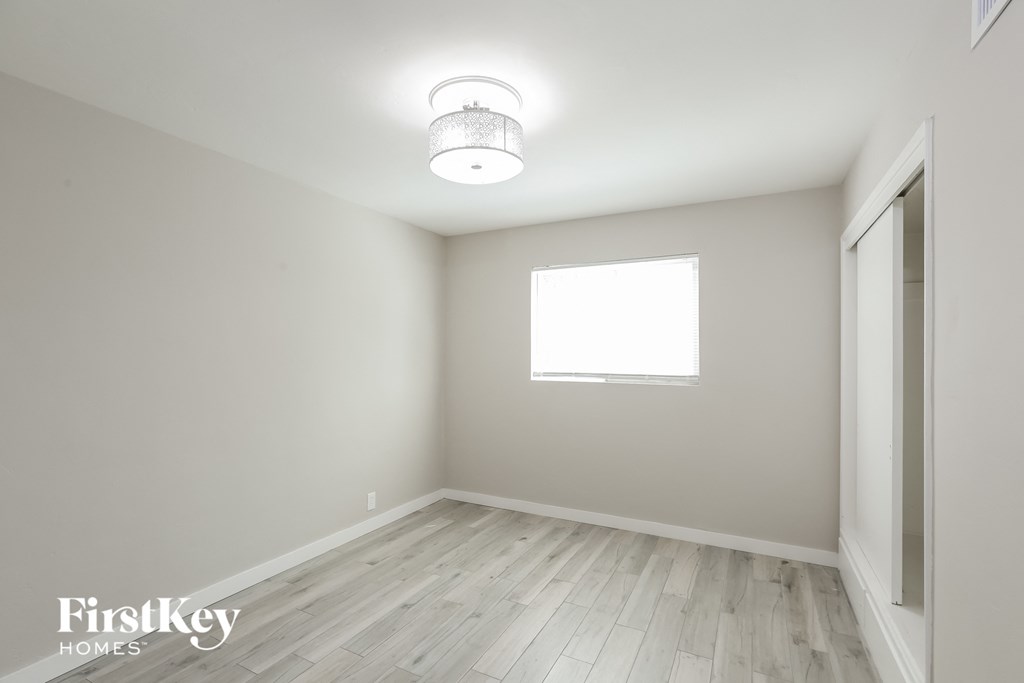 an empty room with white walls and a window