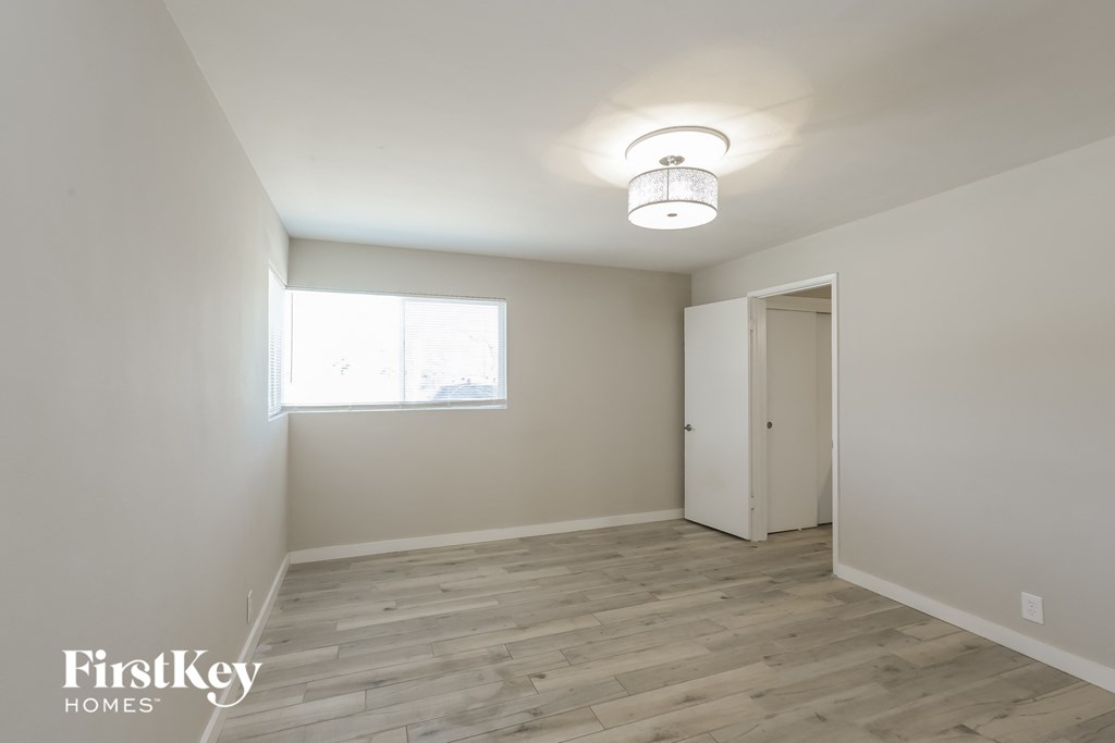 an empty room with white walls and a window