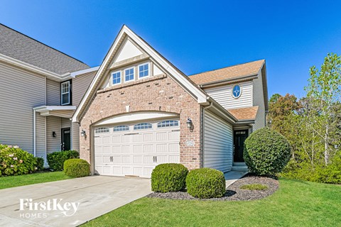A house with a garage door and a driveway.