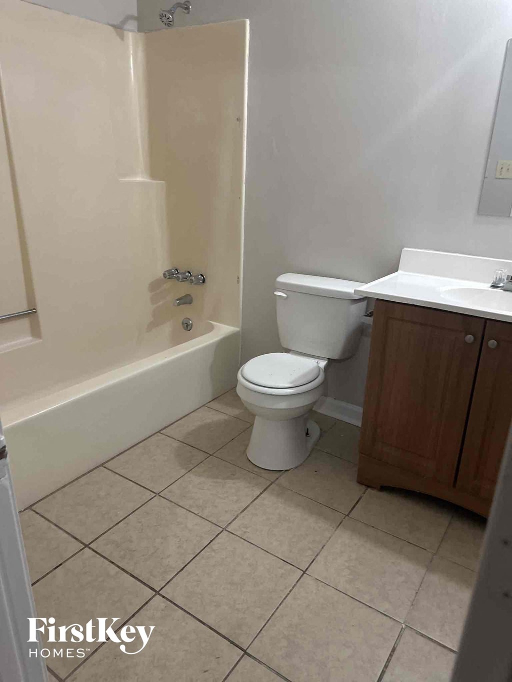 a bathroom with a toilet and a tub and a sink