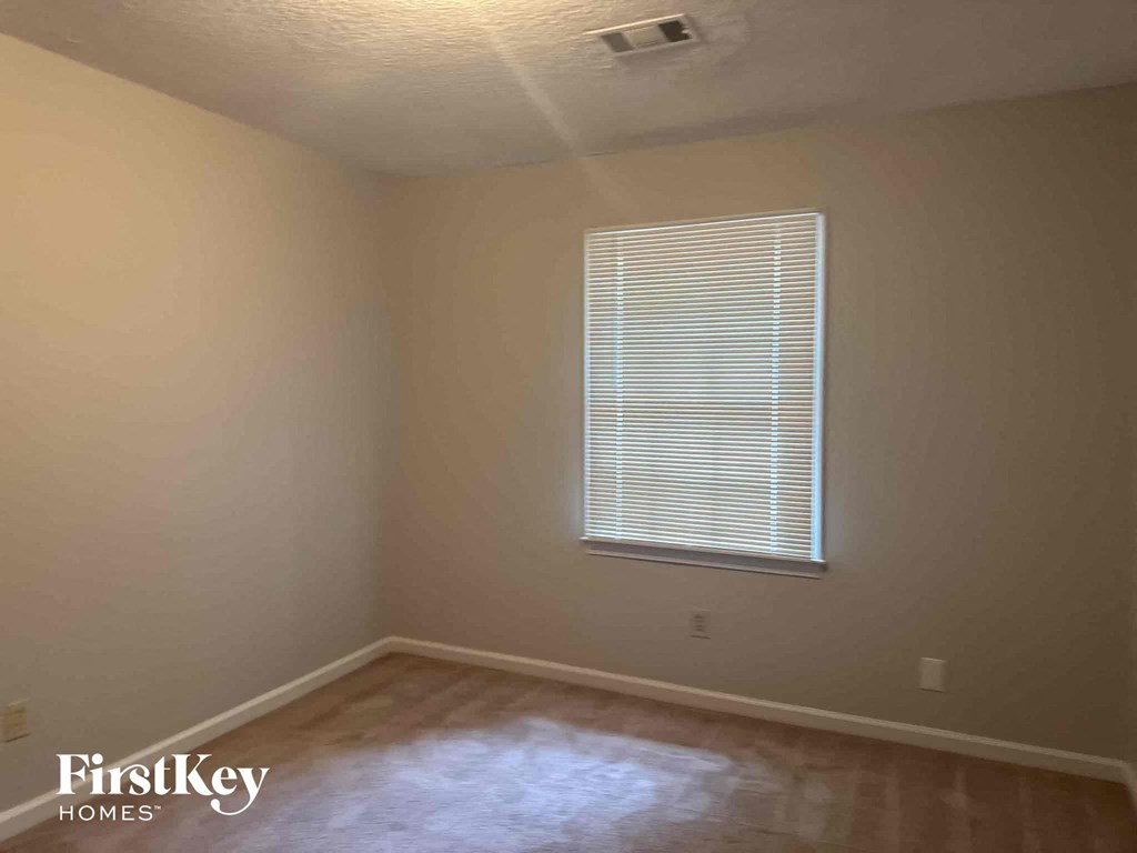 a room with a window and a wooden floor
