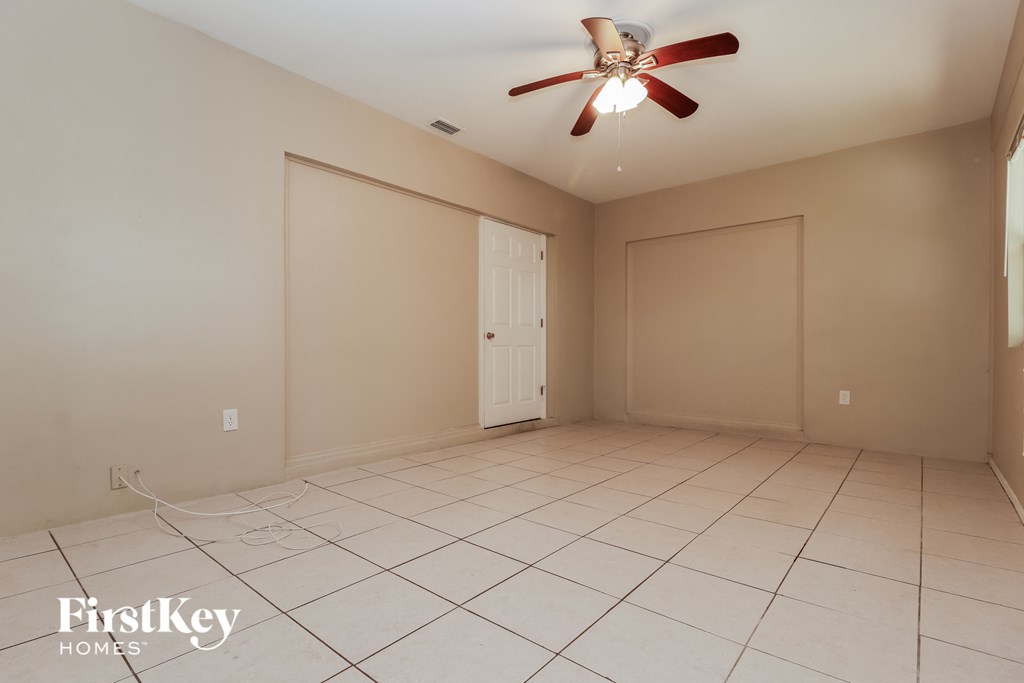 a empty living room with a ceiling fan