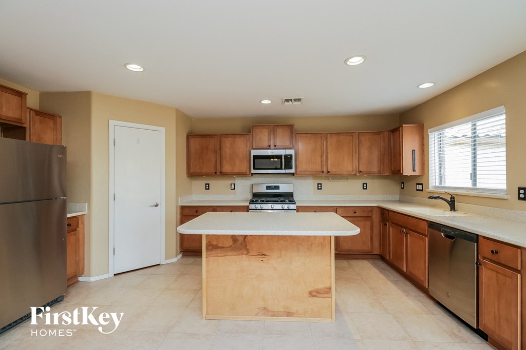 a kitchen with wooden cabinets and a white counter top