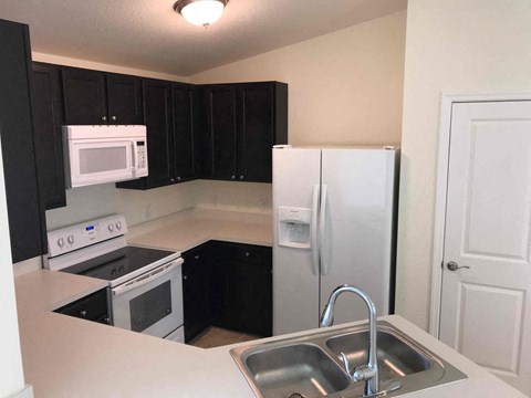 a kitchen with a sink and a refrigerator