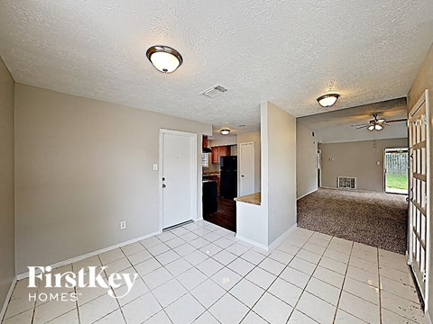 the spacious living room and dining room are open to the kitchen and entryway