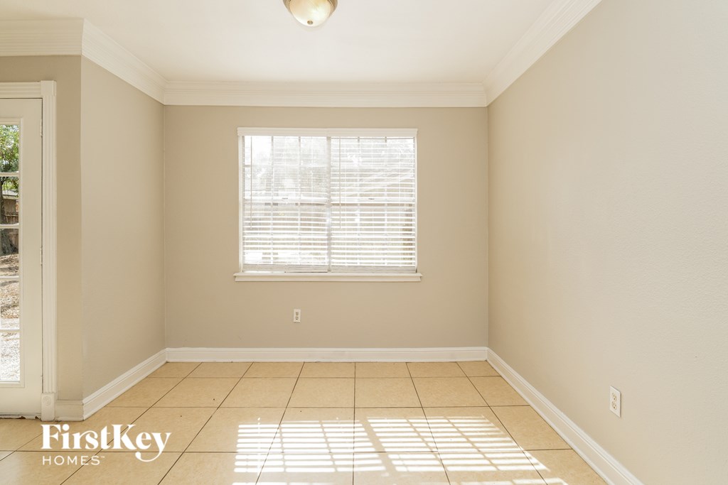 A room with a window and a tiled floor.