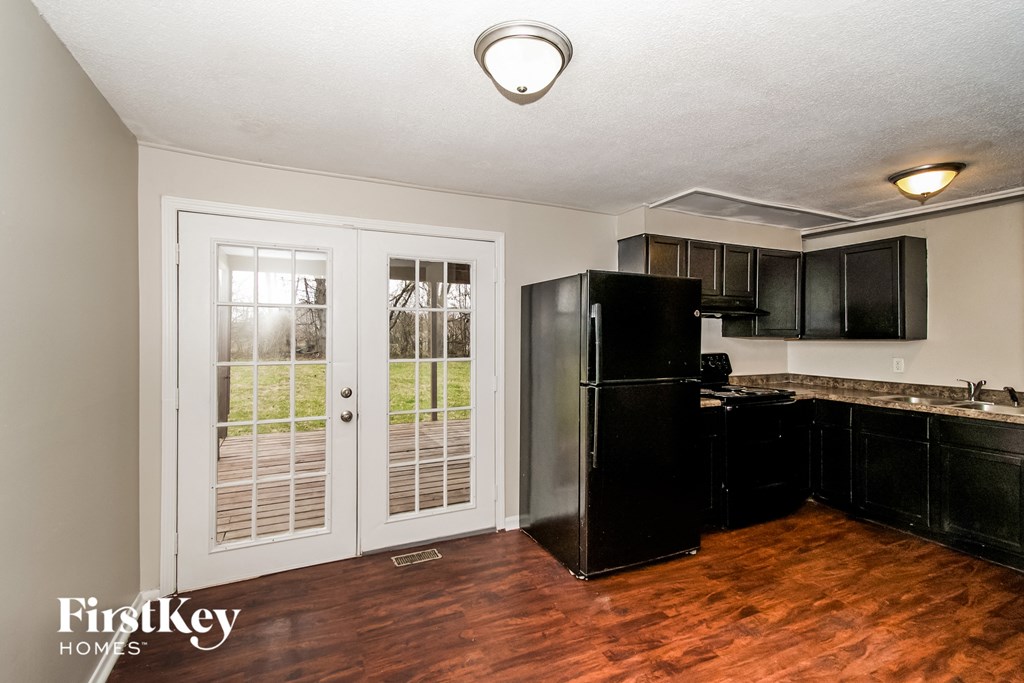 a kitchen with black appliances and a black refrigerator