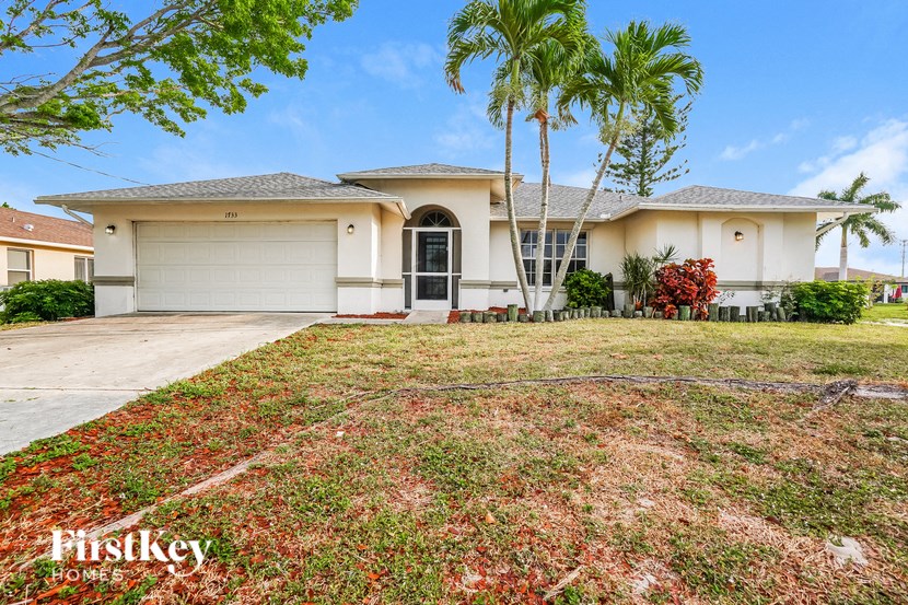 a house with palm trees in front of it