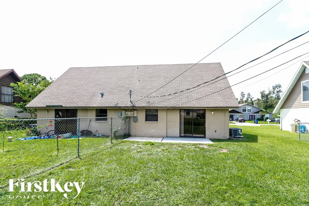 A house with a fence and a grassy yard.