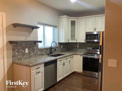 A kitchen with a stove top oven and a microwave.
