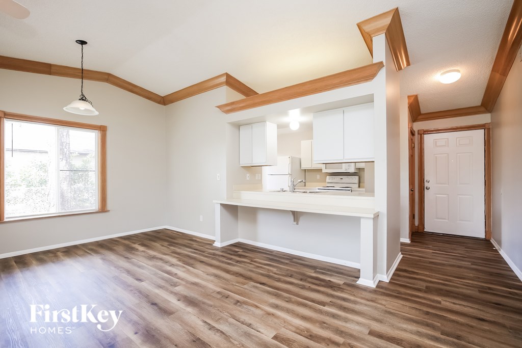 A room with wooden floors and a white cabinet.