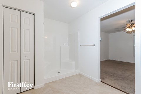 a bedroom with a closet and a door to a bathroom