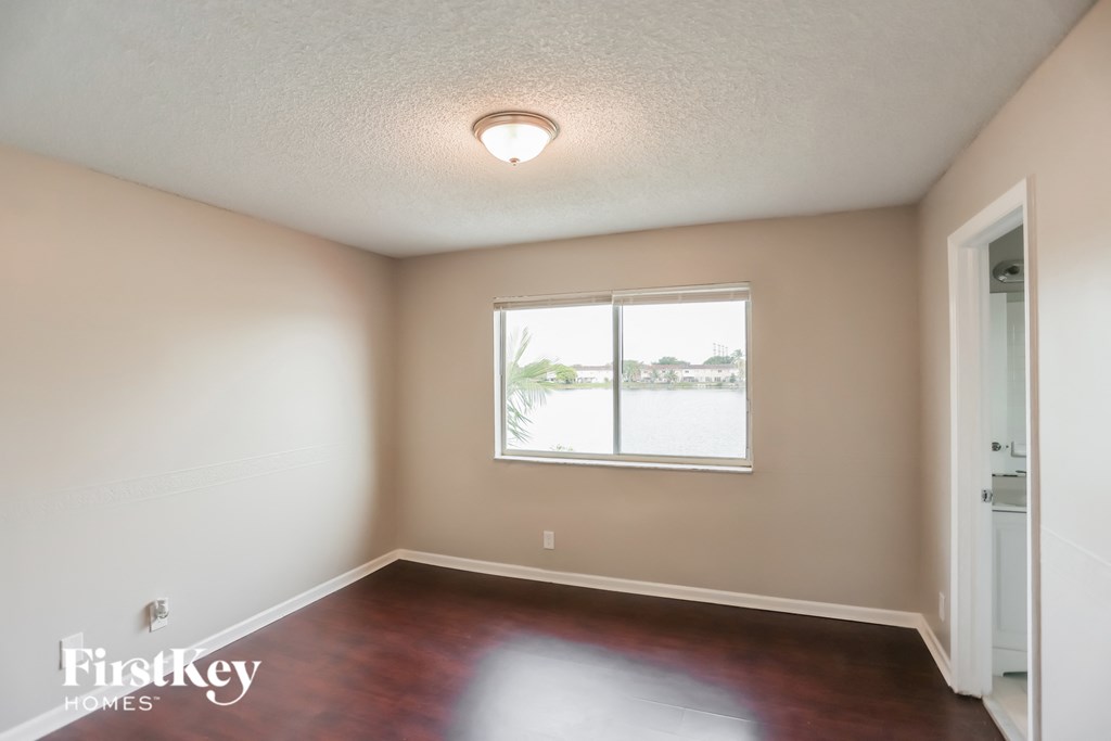 a empty living room with a window and a door