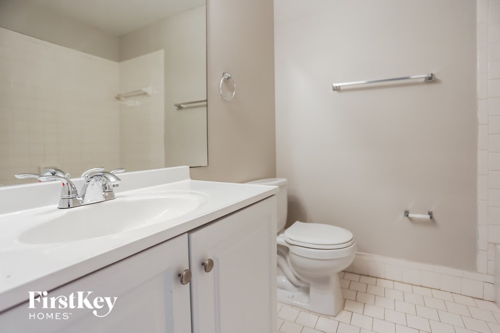 a white bathroom with a sink and a toilet