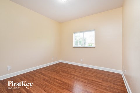 a living room with wood flooring and a window