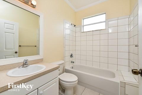 a white bathroom with a toilet sink and tub