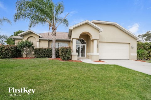 A house with a palm tree in front of it.