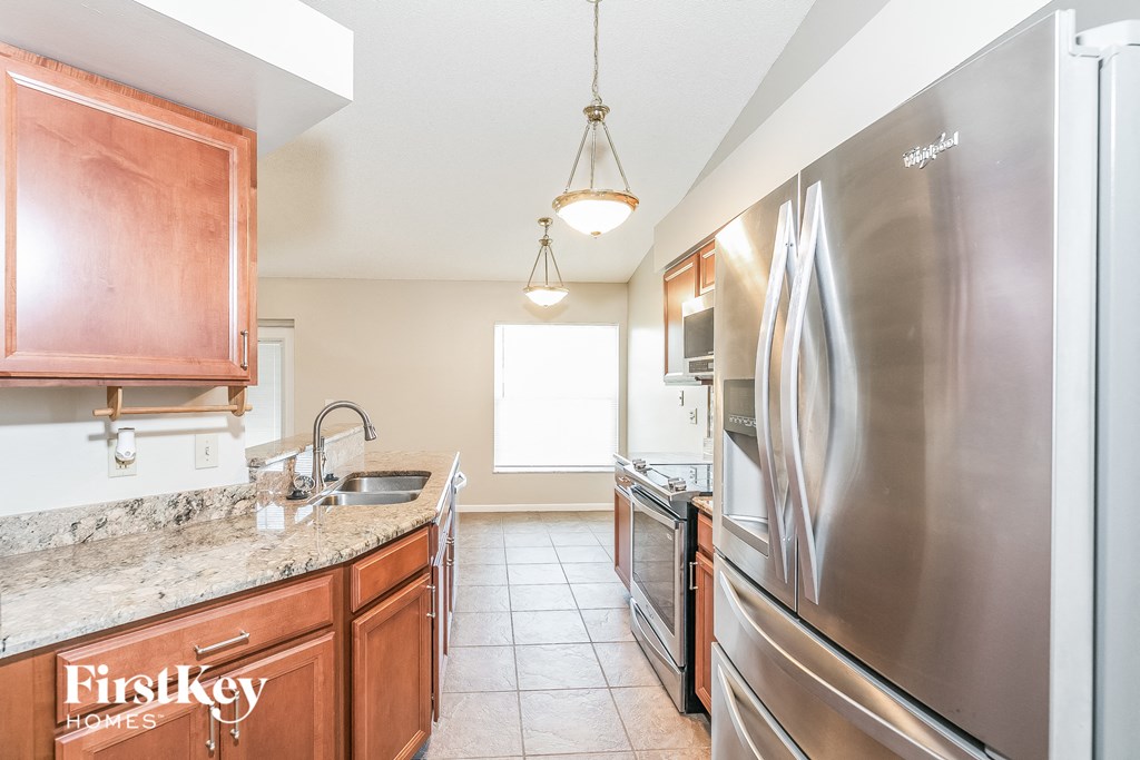 a kitchen with stainless steel appliances and granite counter tops