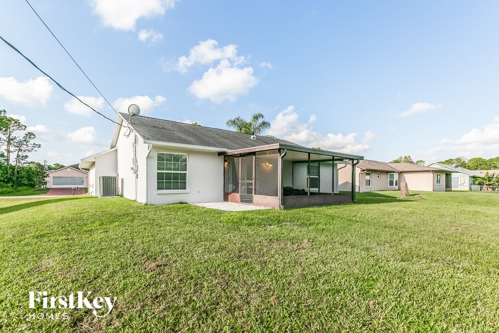 a white house with a grassy yard in front