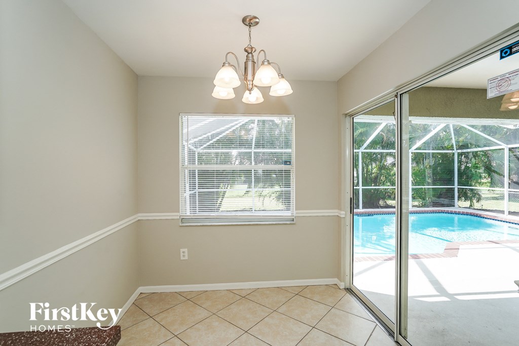 A room with a pool visible through the glass door.
