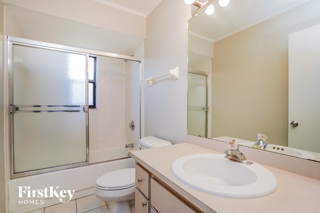 A white bathroom with a FirstKey Homes logo.