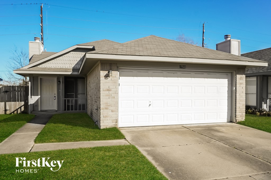a white garage door in front of a house